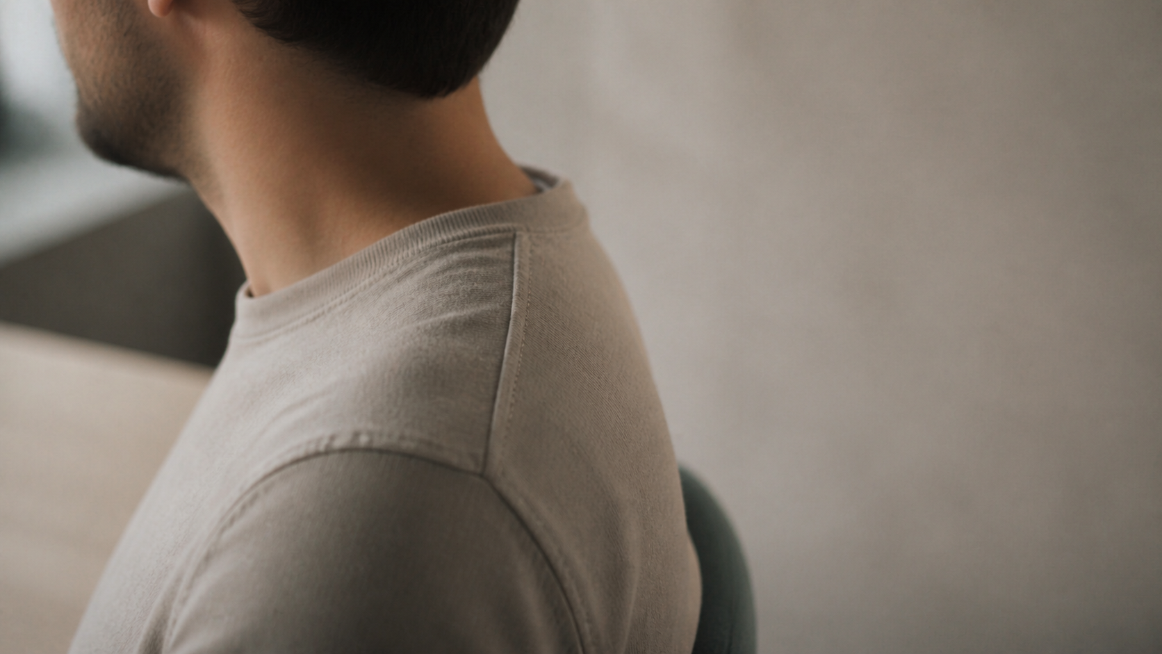 Close profile detail of a professional's shoulder and neck at rest