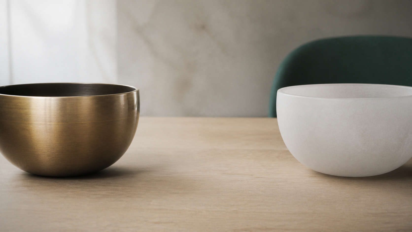 Brushed bronze and frosted quartz singing bowls separated by clean space